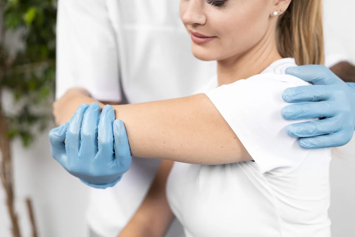 Physiotherapist checking a patient's shoulder flexibility